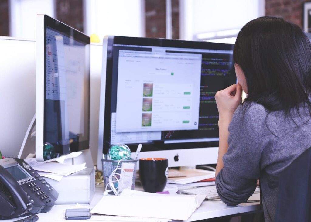 a office worker is seeing monitors